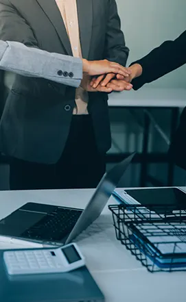 Business partners joining hands to represent successful collaboration with Procurement Outsourcing Companies in Florida.