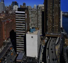 Modern corporate architecture and busy transit routes in California, highlighting the infrastructure supported by a local Procurement Company in California.