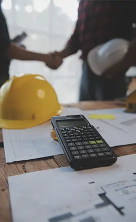 Close-up of a contract signing and calculator, highlighting Procurement Advisory Firms in New Jersey specializing in budget optimization and vendor agreements.
