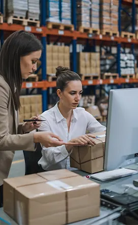 A focused woman taking notes during a strategy session at one of the Best Procurement Consulting Firms in New York.
